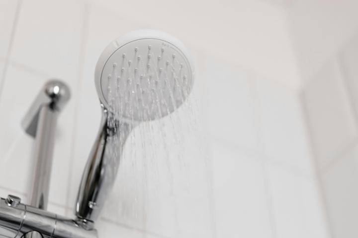 Close up of shower head spraying water