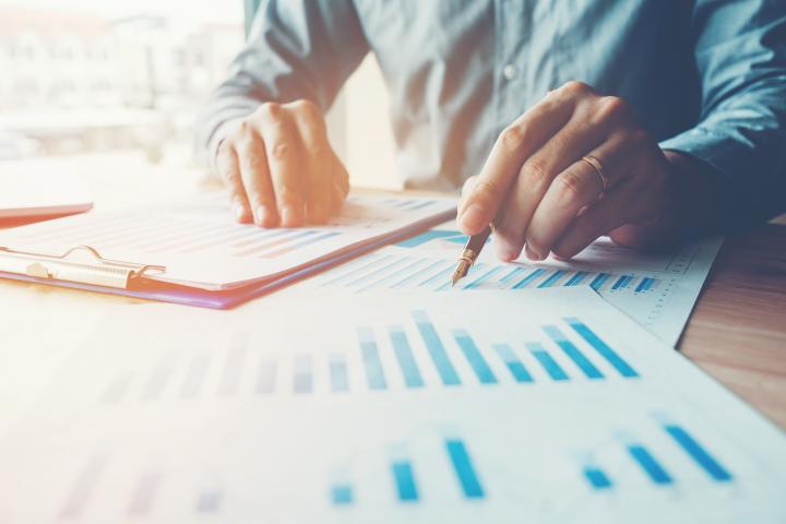A man sitting at a table looking over a series of charts