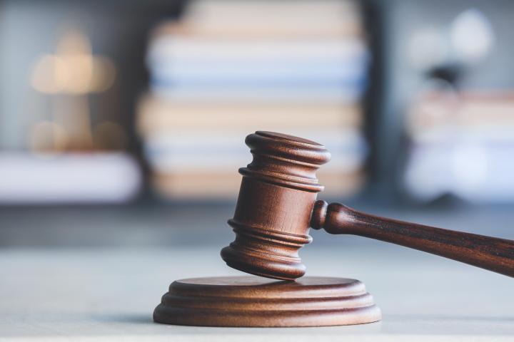 A judge's gavel resting on a table in an office