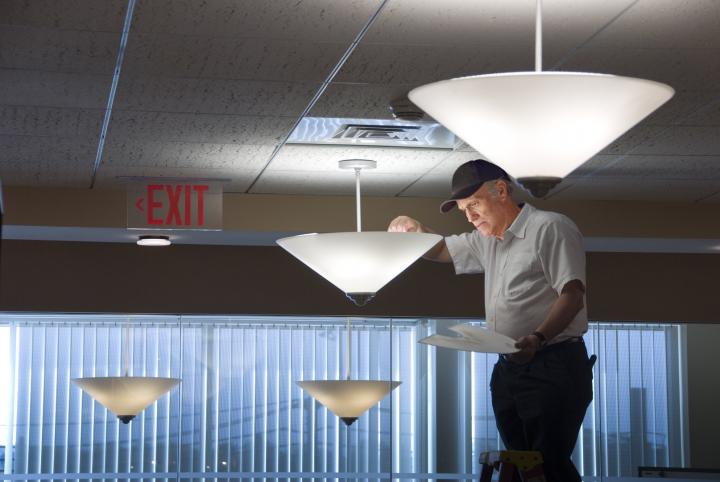 Electrician changing a light bulb