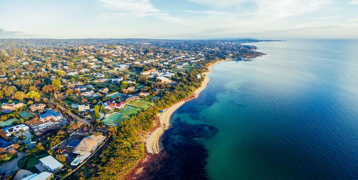 An aerial photo showing the Mornington Peninsula and Port Phillip on one side, and the ocean on the other.