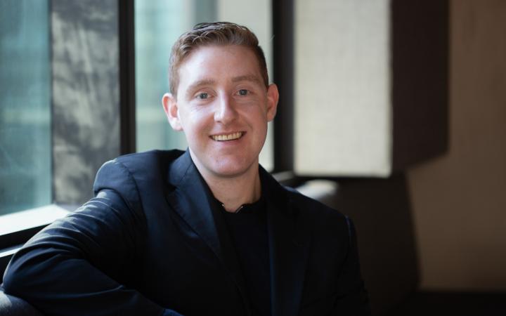 Nathan, an Essential Services Commission employee sitting and smiling in an office