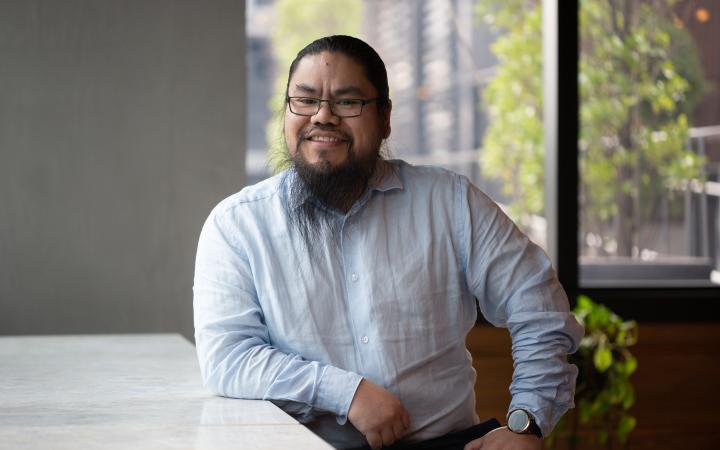 Patrick, an Essential Services Commission employee sitting and smiling in an office