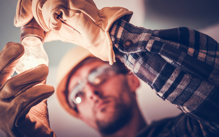 Man installing lightbulb