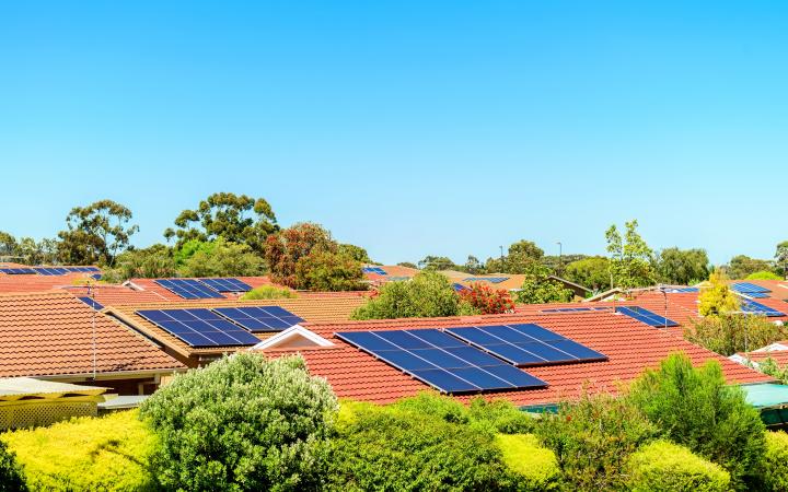 An image showing solar panels on house rooftops