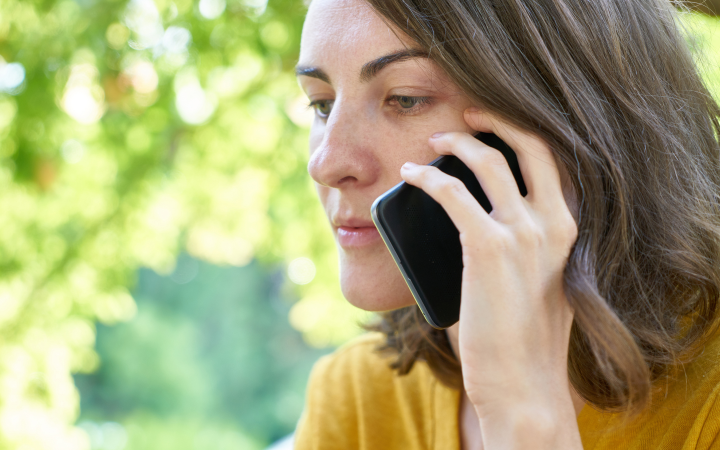 Woman looking anxious while holding a mobile phone