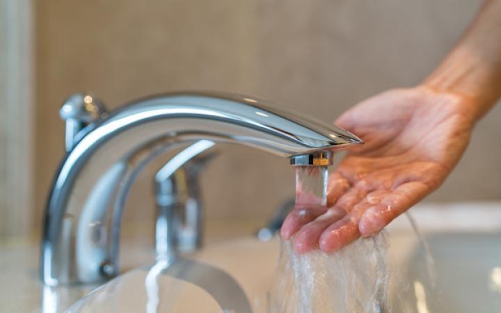 Hand under running tap