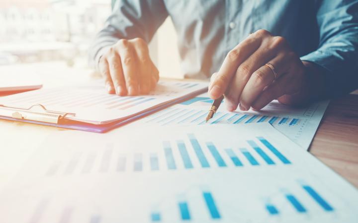 A man sitting at a table looking over a series of charts