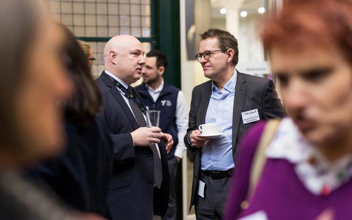 An image of two men chatting to each other at the commission's family violence forum on 30 August 2018.