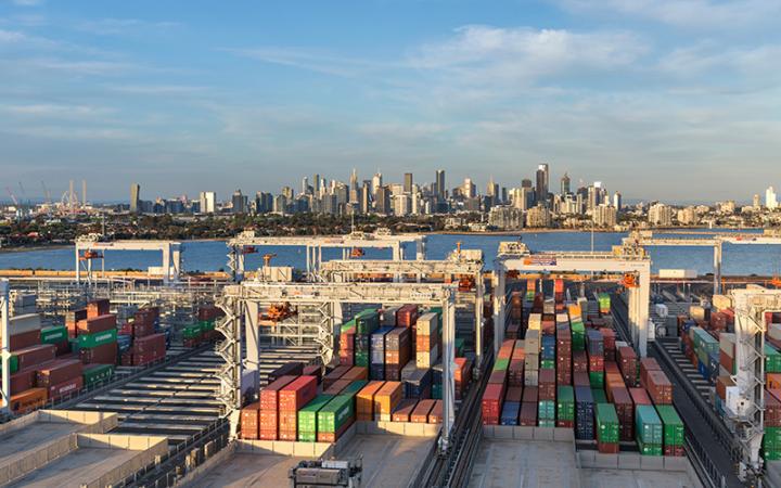 Shipping containers at the Port of Melbourne with the Melbourne CBD in the background