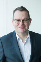 A profile photo of John Hamill, CEO of the Essential Services Commission